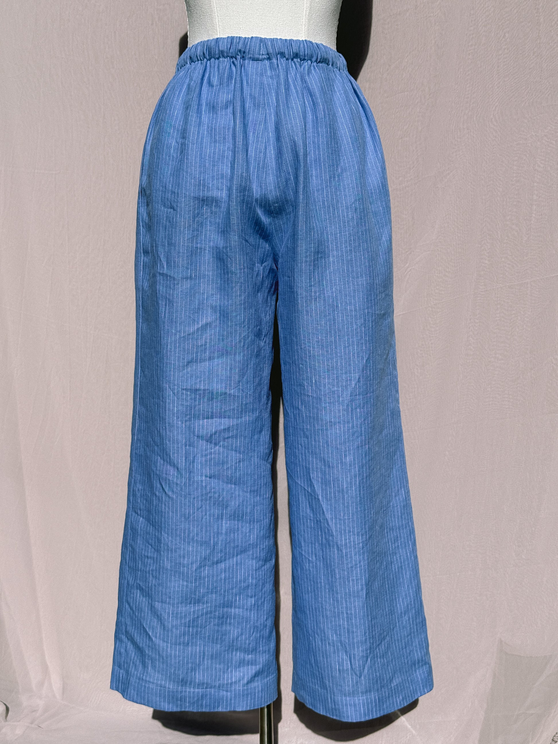 Blue pinstripe wide-leg pants on a mannequin against a plain background