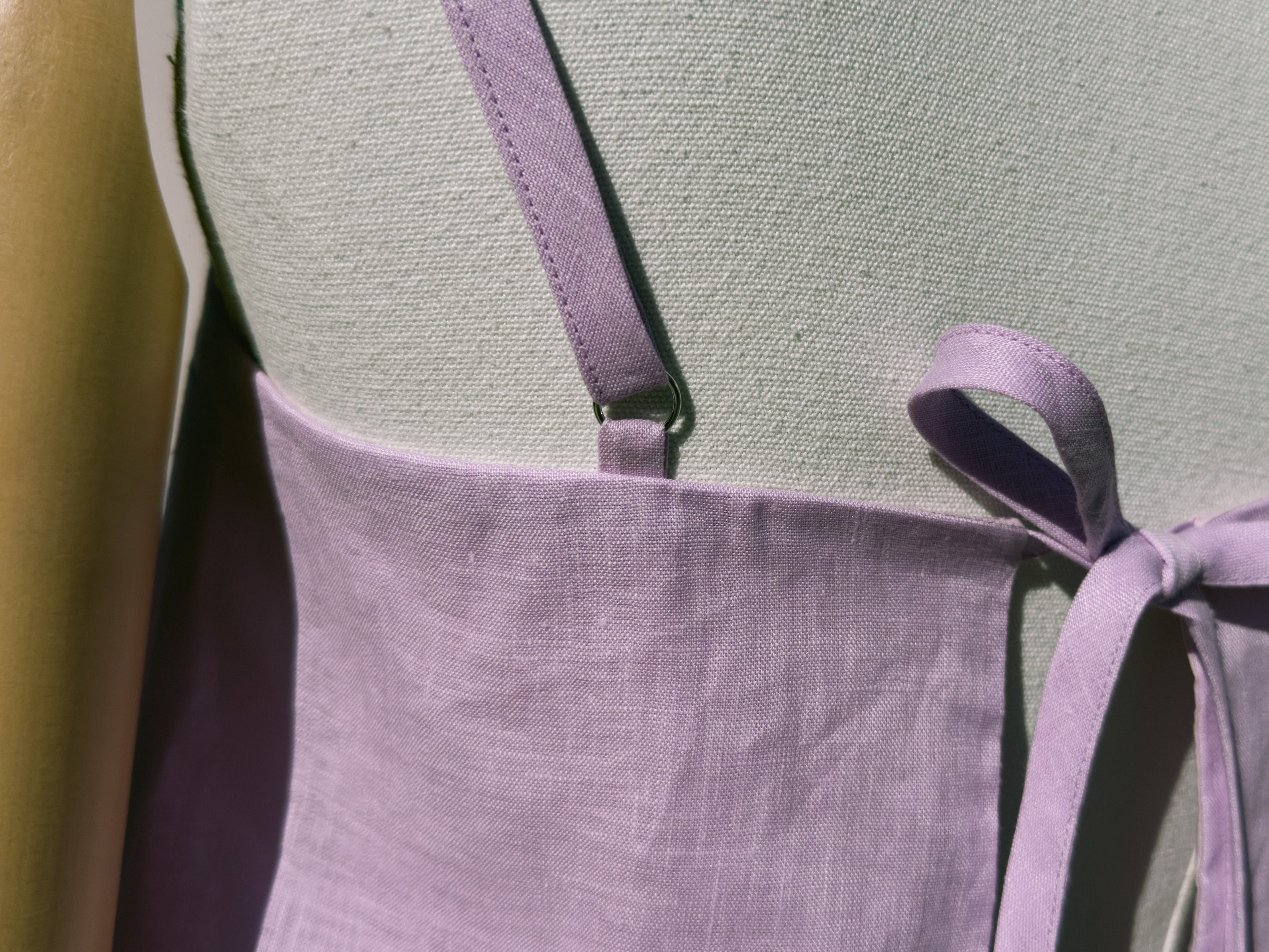 Close up of lilac linen top with back tie on mannequin