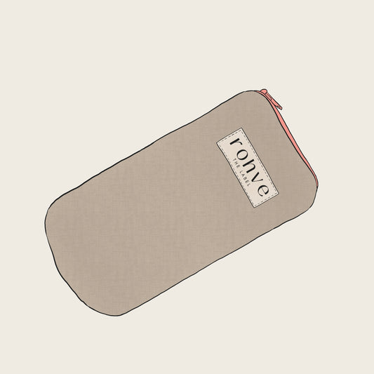 Beige pouch with a brand label on a light beige background sketch