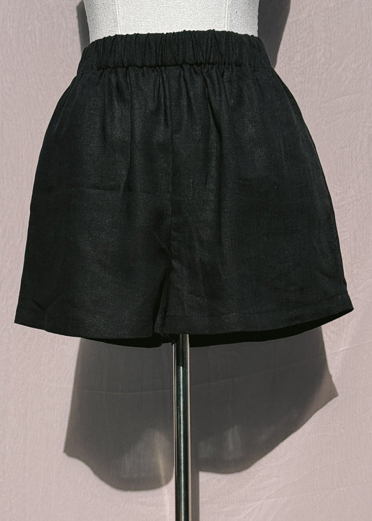 Black linen shorts on a mannequin against a plain background