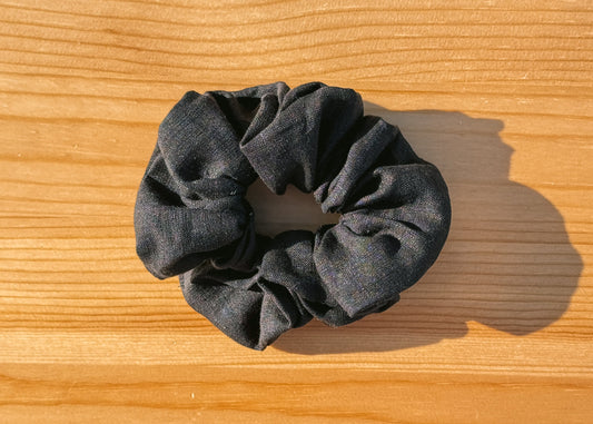 Black scrunchie on a wooden surface