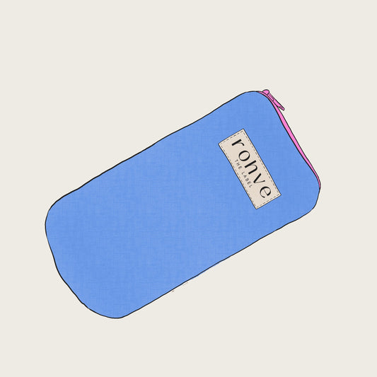 Blue pouch with a brand label on a light beige background sketch