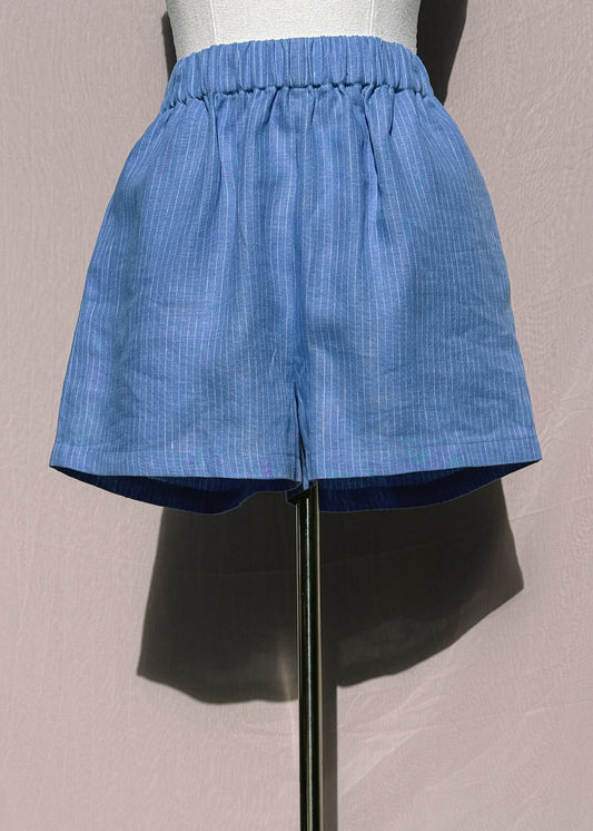 Blue stripe linen shorts on a mannequin against a plain background