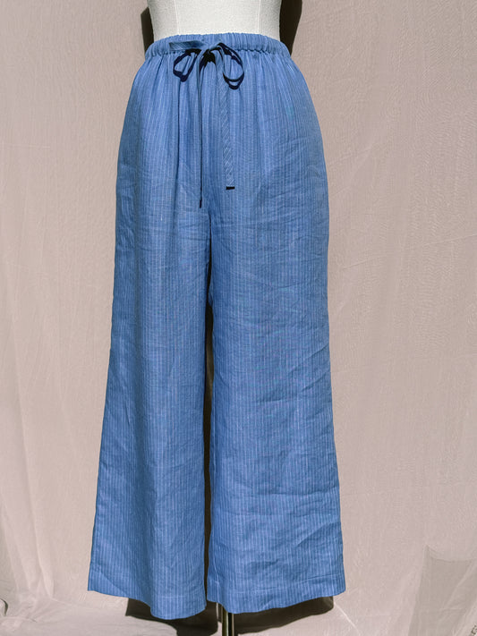 Blue stripe wide-leg pants with waist tie on a mannequin against a plain background
