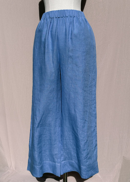 Blue pinstripe pants on a mannequin against a neutral background