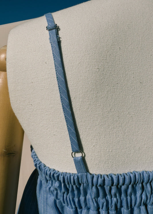 Close up of blue linen top on mannequin 