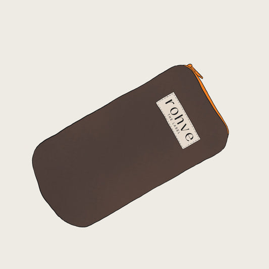 Brown pouch with a brand logo on a beige background with orange zipper sketch
