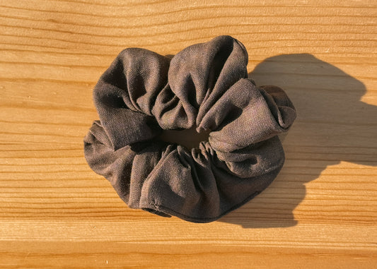 Brown scrunchie on a wooden surface