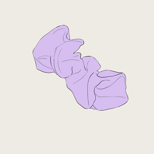 Purple scrunchie on a light beige background