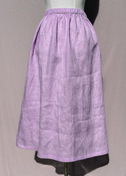 Lilac linen skirt on a mannequin against a plain background